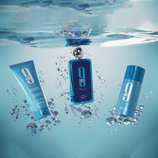 Afnan 9AM Pour Femme gift set featuring perfume, shower gel, and deodorant beautifully submerged in clear blue water with bubbles, creating a refreshing aquatic effect that highlights the fragrance’s fresh and vibrant theme.