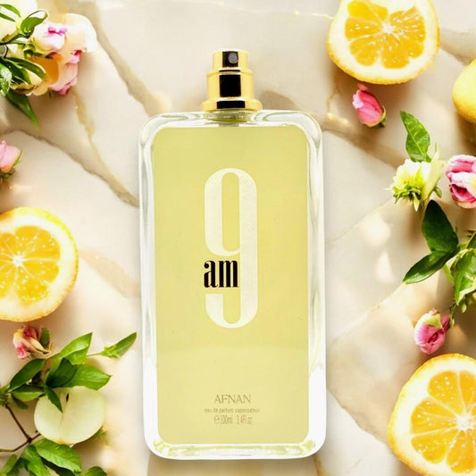 Afnan 9AM Eau De Parfum bottle with citrus and floral background.