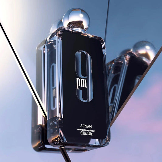 Afnan 9PM perfume bottle with reflective background.