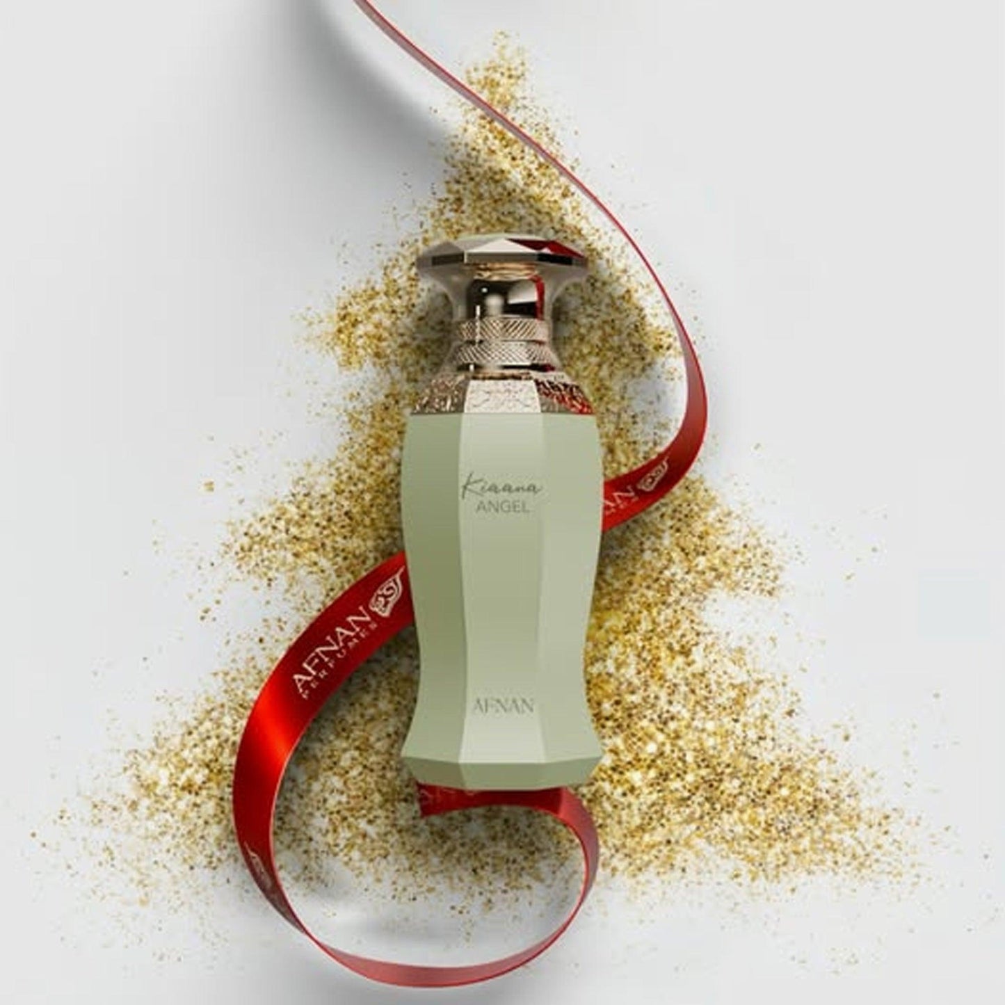 Afnan Karamat Angel Eau De Parfum in an elegant pastel green bottle with gold accents, surrounded by golden shimmer and a red Afnan ribbon for a festive, luxurious display