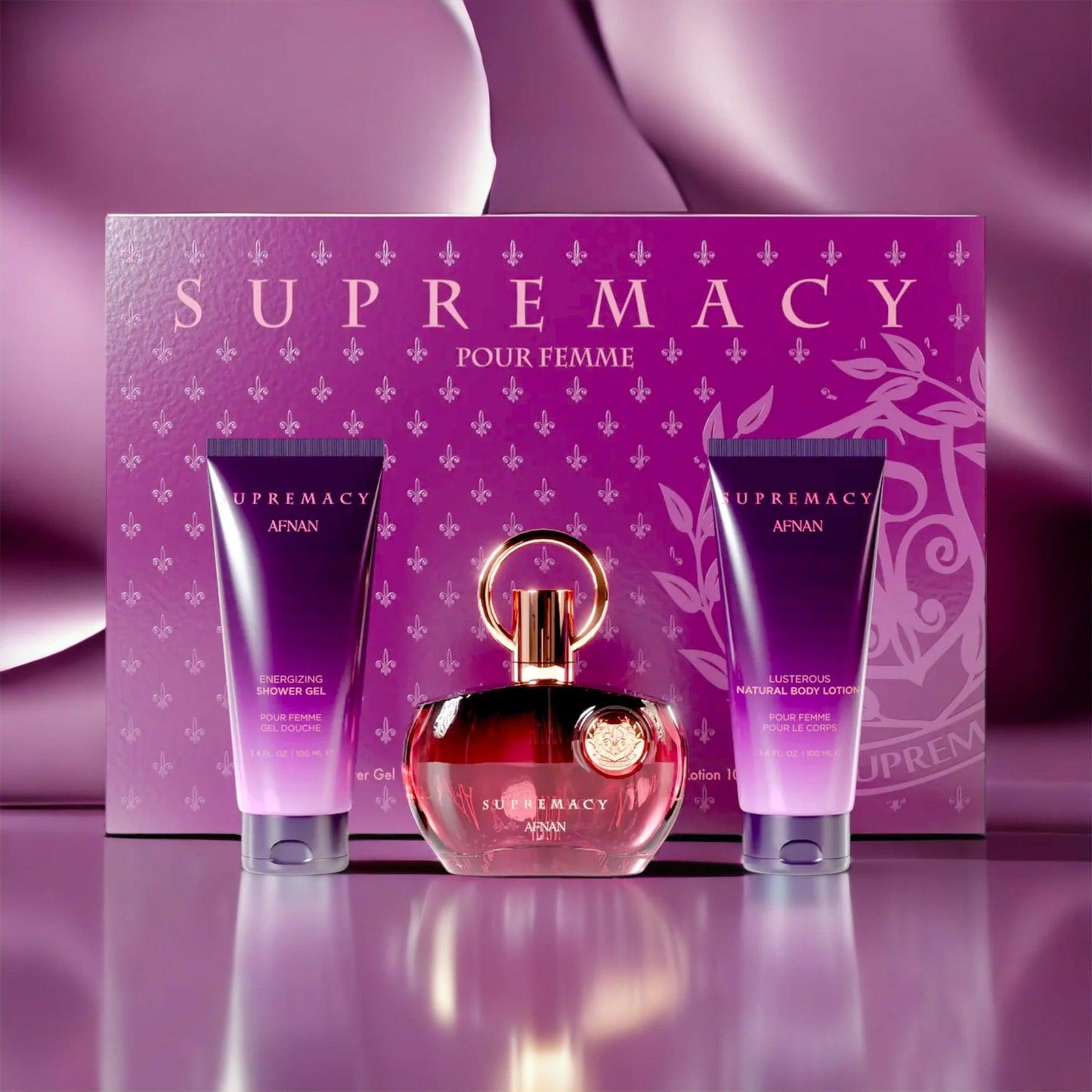 Afnan Supremacy Pour Femme gift set displayed against a luxurious purple background, featuring the elegant red and gold perfume bottle, matching shower gel, and body lotion beside the beautifully designed purple box.