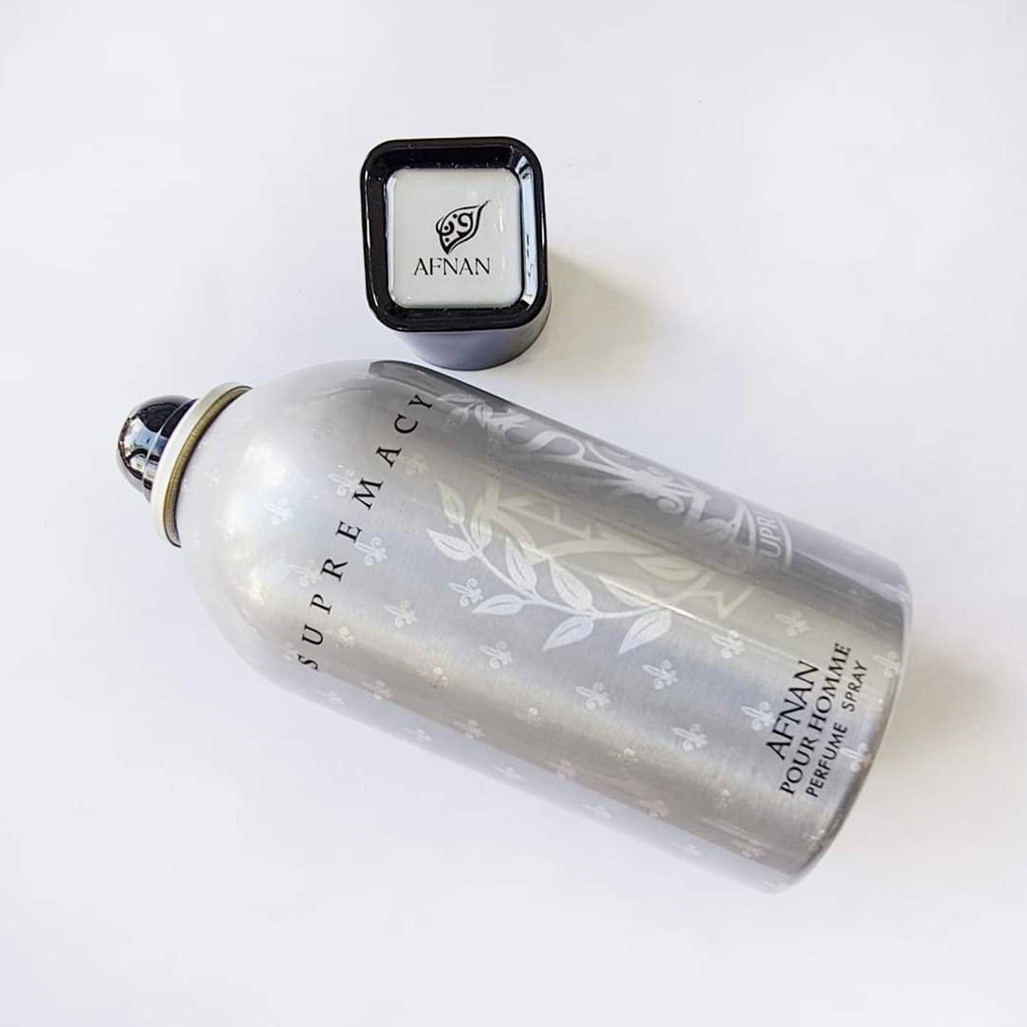 Afnan Supremacy Pour Homme perfume spray bottle on white background.