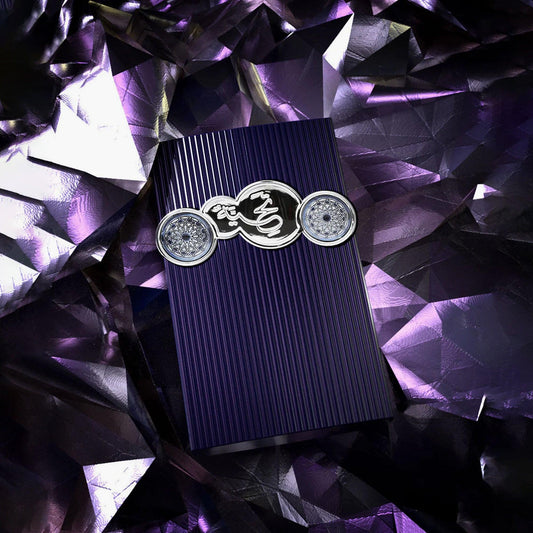 Afnan Supremacy Purple Eau De Parfum bottle with vertical textured design and silver emblem displayed on a reflective purple crystal background