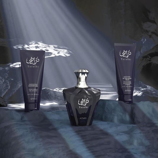 Afnan Turathi Blue gift set displayed in a rocky cave setting with rays of light shining through, featuring the elegant dark blue perfume bottle alongside matching shower gel and after-shave balm.