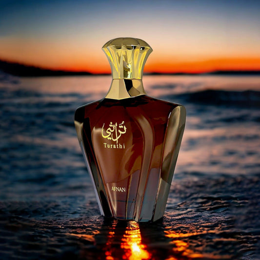 Afnan Turathi Eau De Parfum elegant gold and amber bottle placed on water reflecting the sunset, creating a warm and luxurious atmosphere