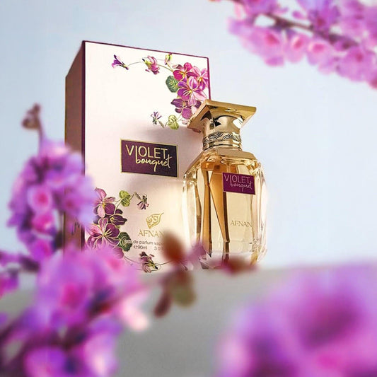 Afnan Violet Bouquet Eau De Parfum bottle and box design surrounded by blooming purple flowers with a soft pastel background
