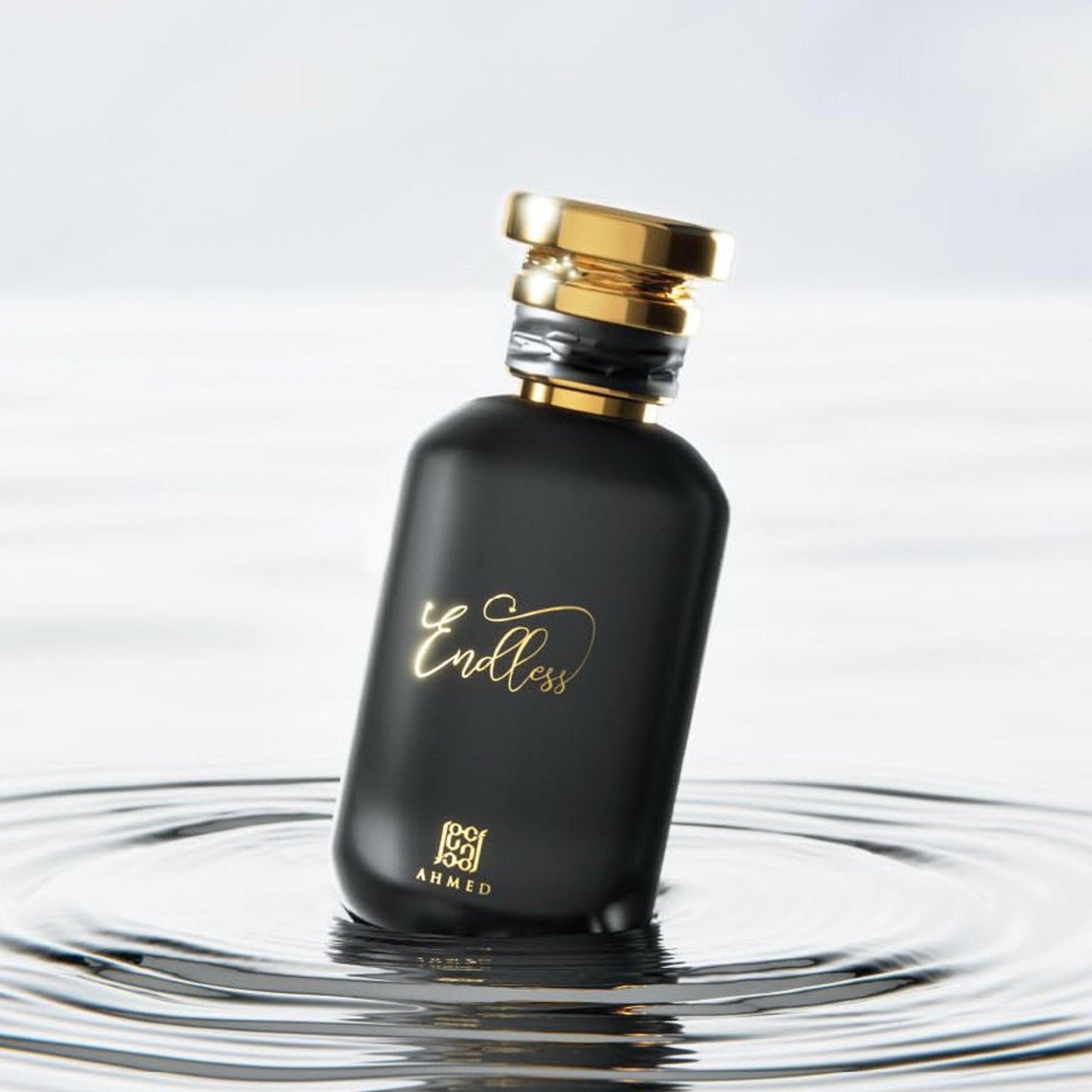 Ahmed Endless Eau De Parfum in a sleek matte black bottle with gold detailing, elegantly positioned on rippling water for a luxurious and modern visual effect