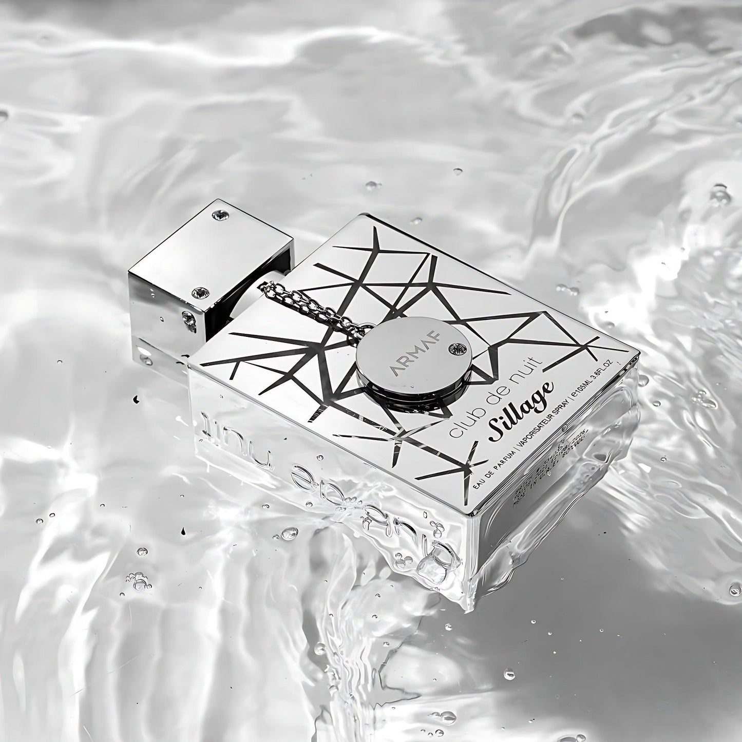 Armaf Club De Nuit Sillage perfume bottle on reflective water surface.