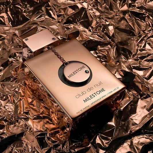 Armaf Club De Nuit Milestone Eau De Parfum bottle in elegant gold finish placed on metallic gold background, symbolizing luxury and sophistication