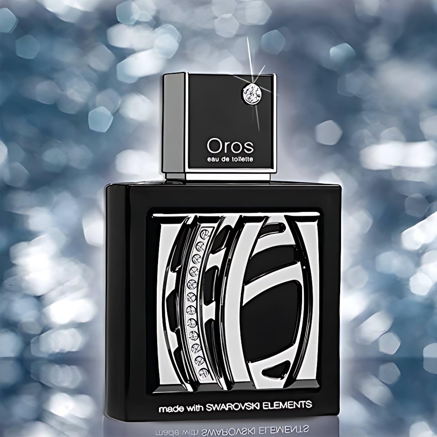 Oros Eau De Toilette perfume bottle with Swarovski crystal detailing in black and silver design displayed against a sparkling blue bokeh background