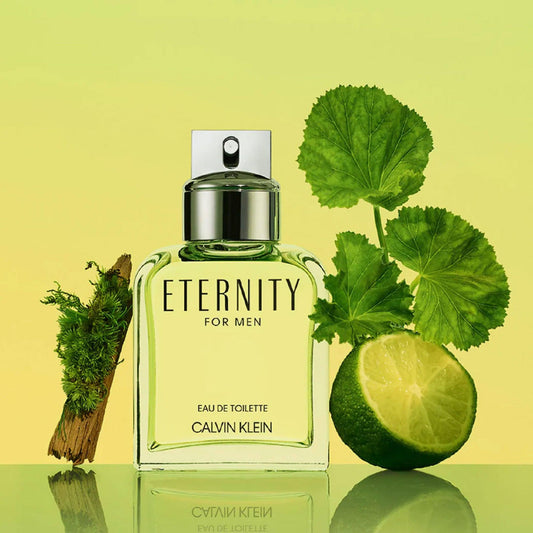 Calvin Klein Eternity for Men Eau De Toilette bottle with lime, green leaves, and wood on a fresh yellow-green background