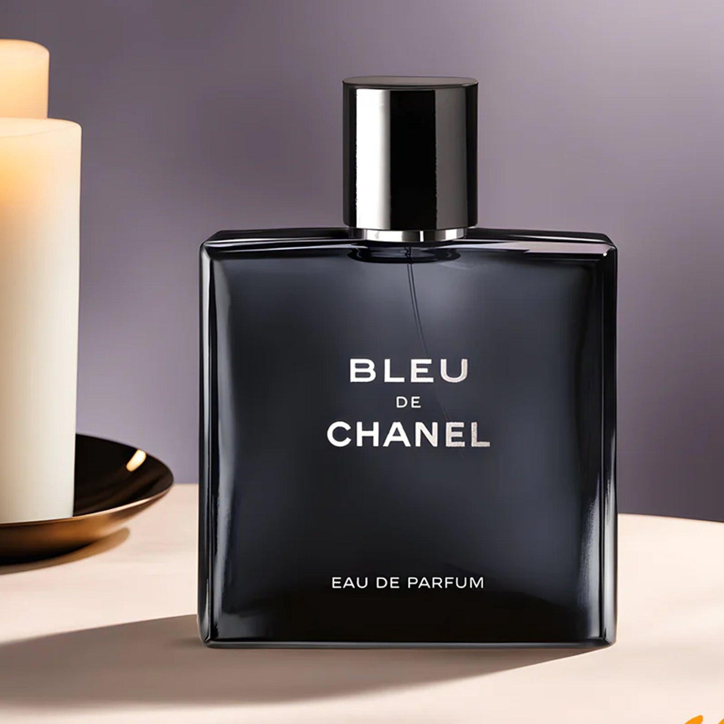 Bleu de Chanel Eau De Parfum bottle displayed beside lit candles on a soft-toned background, highlighting its sleek dark blue design and luxurious masculine aesthetic