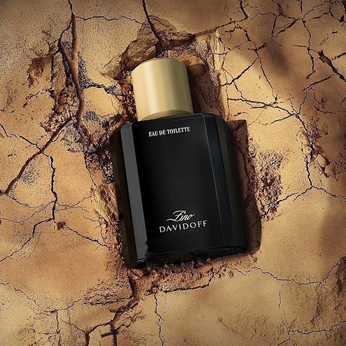 Davidoff Zino perfume bottle on cracked desert Surface