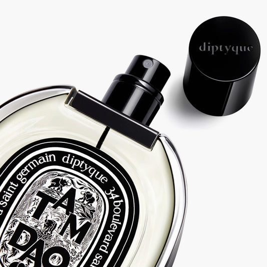 Diptyque Tam Dao perfume bottle with black cap and oval label on white background.