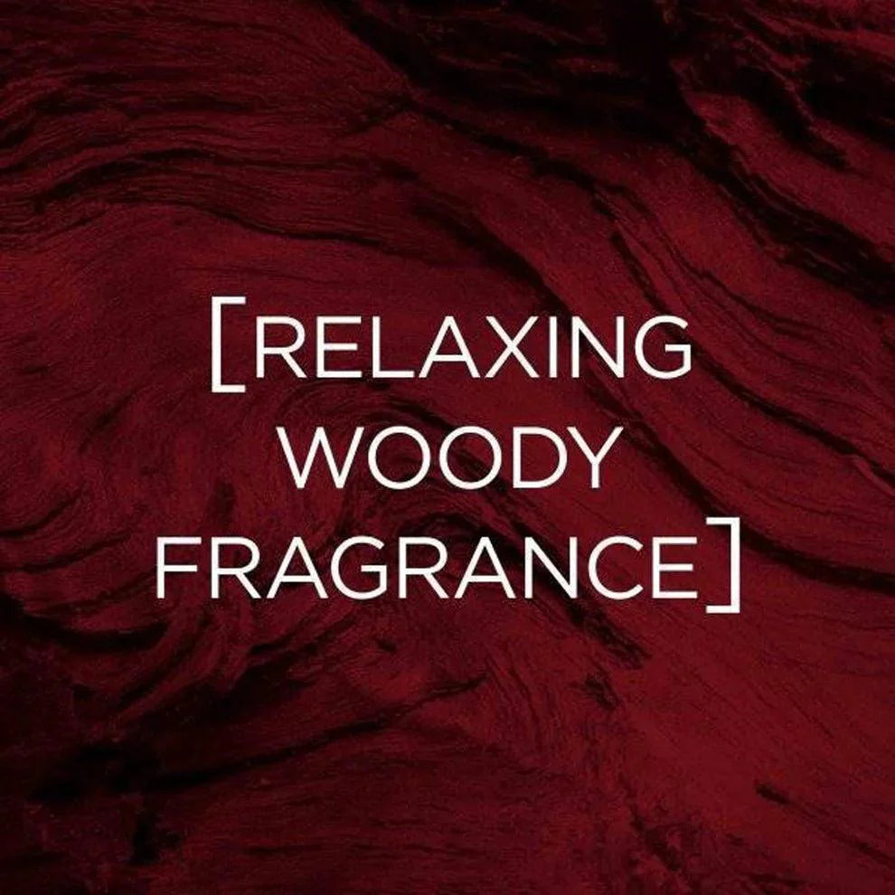 Text reading ‘Relaxing Woody Fragrance’ displayed on a dark red textured wooden background