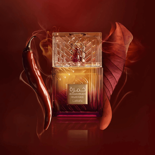 Lattafa Khamrah Dukhan perfume bottle on a warm red background.