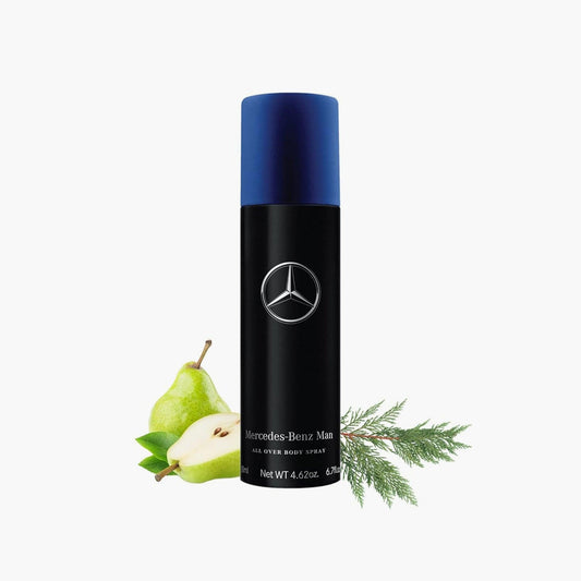 Mercedes-Benz Man All Over Body Spray in a sleek black and blue can, displayed with fresh pears and green cedar leaves, highlighting its fruity and woody fragrance notes
