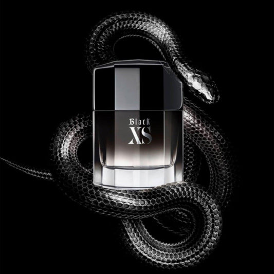 Paco Rabanne Black XS Eau De Toilette bottle with a sleek black gradient design surrounded by a coiled black snake on a dark background