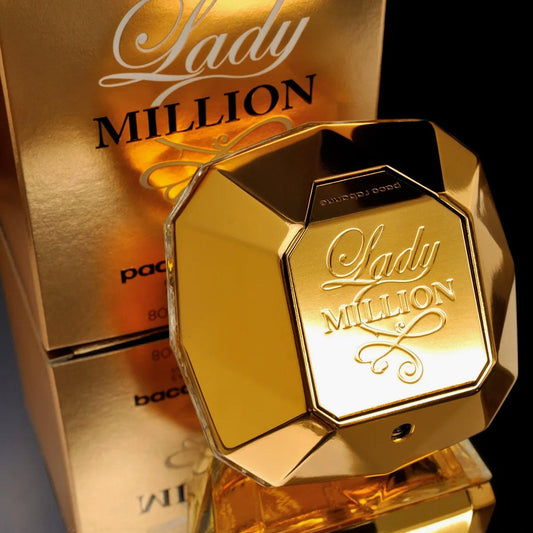 Paco Rabanne Lady Million Eau De Parfum diamond-shaped gold bottle placed in front of its matching golden packaging box, showcasing a luxurious and elegant design