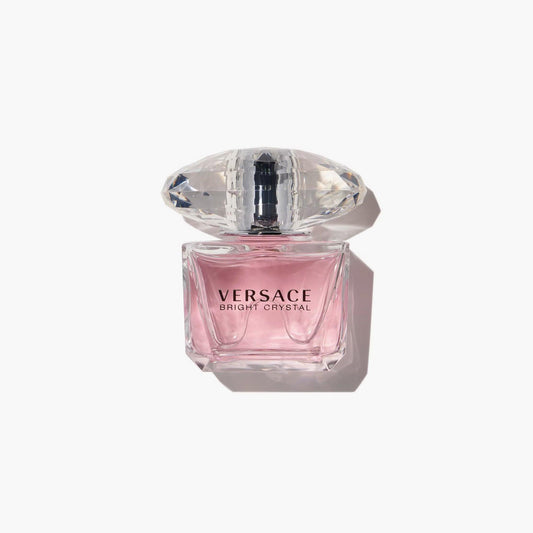 Versace Bright Crystal perfume bottle with pink liquid and crystal cap on white background