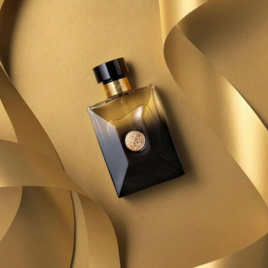 Versace Pour Homme Dylan Blue perfume bottle in black and gold on golden background