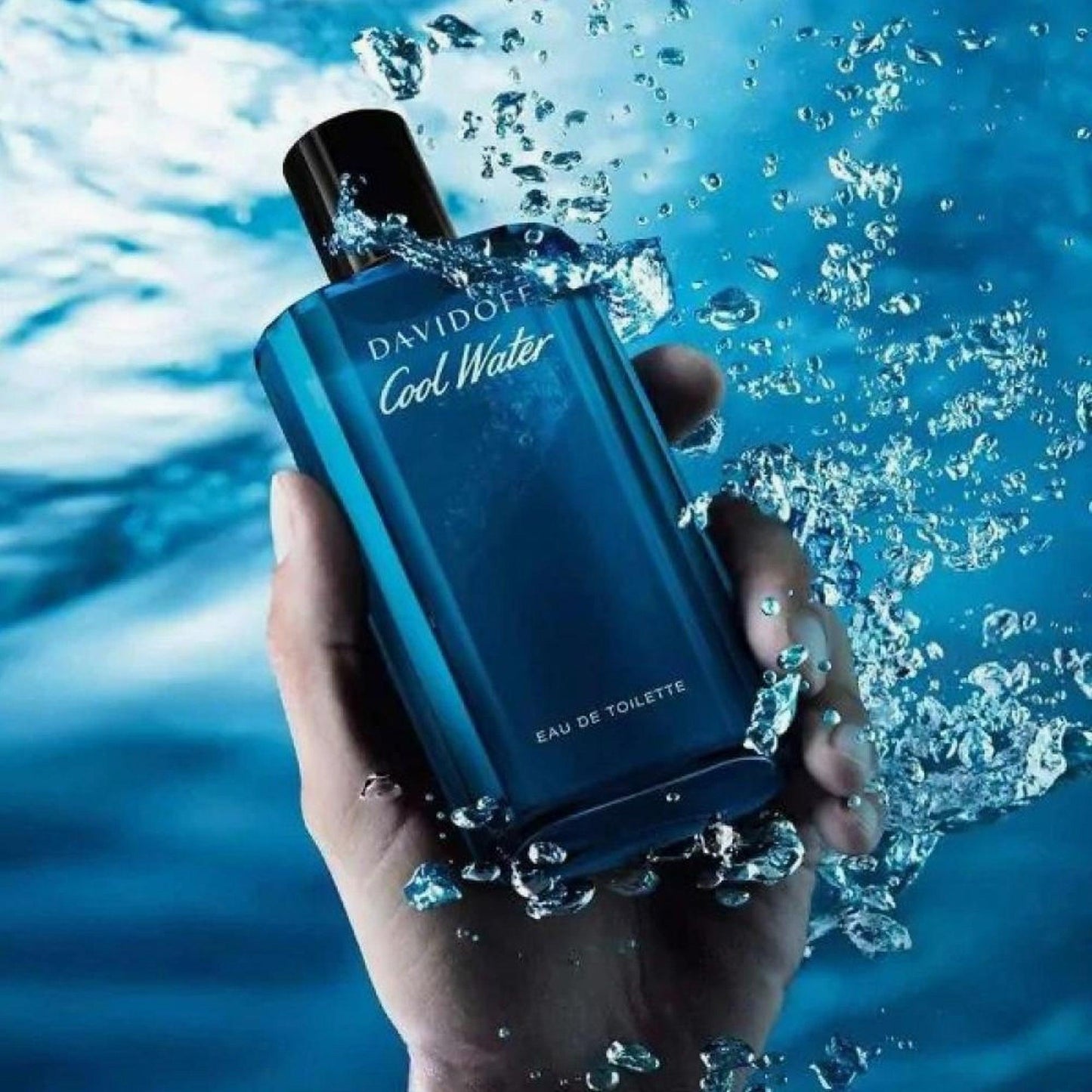 Davidoff Cool Water perfume bottle held in hand in water.