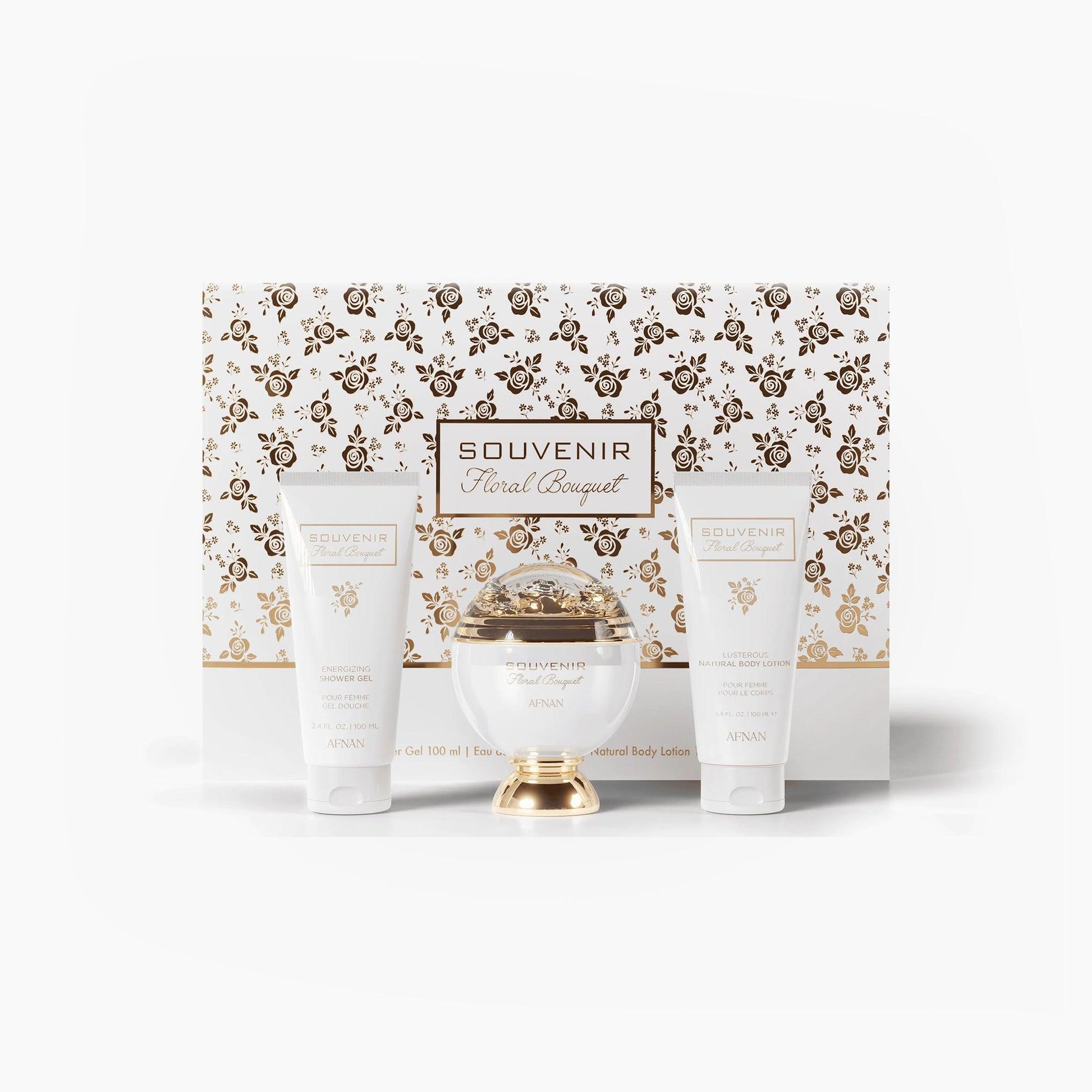 Afnan Souvenir Floral Bouquet gift set featuring a white and gold perfume bottle, matching shower gel, and body lotion placed in front of an elegant floral-patterned presentation box.