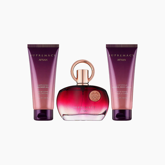 Afnan Supremacy Pour Femme gift set featuring a red and gold perfume bottle with matching shower gel and body lotion, creating an elegant and feminine presentation.