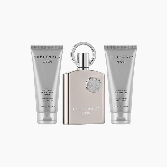 Afnan Supremacy Silver gift set featuring a sleek metallic perfume bottle, an energizing shower gel, and a soothing after-shave balm, all in coordinated silver packaging on a white background.