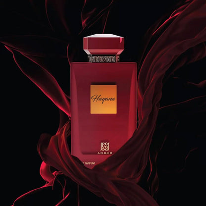 Ahmed Hayana Eau De Parfum in a bold red bottle with a gold label, elegantly surrounded by flowing red fabric on a dark background, creating a luxurious and passionate aesthetic