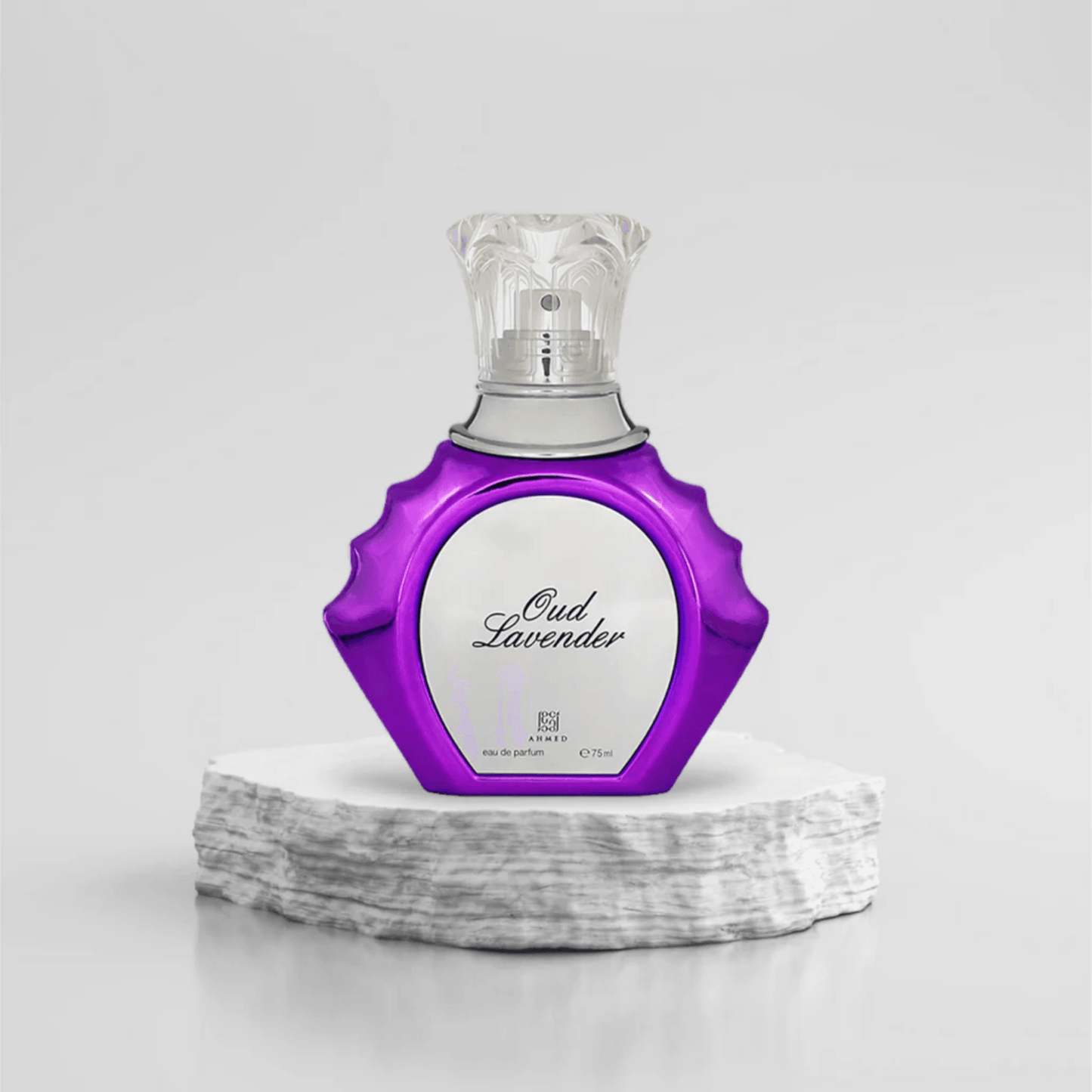 Oud Lavender Eau De Parfum 75ml in a stylish purple and silver bottle with an ornate transparent cap placed on a white stone base against a light background