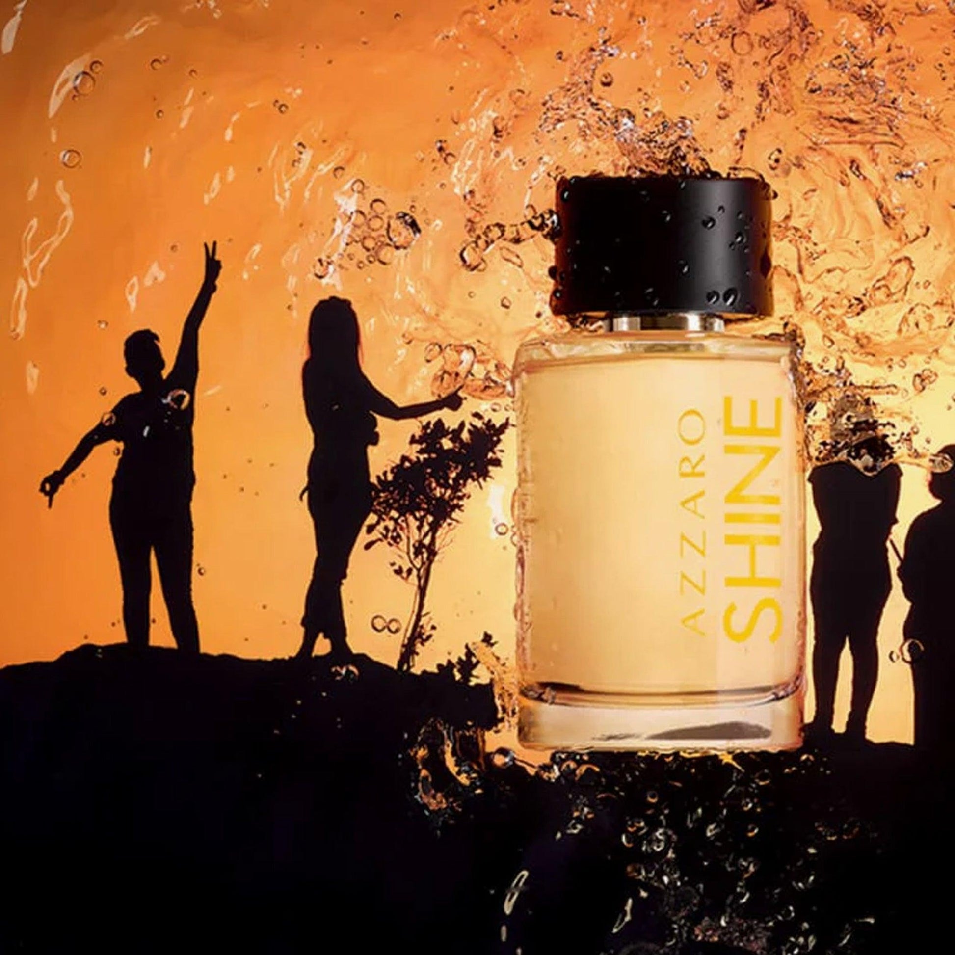 Azzaro Shine Eau De Toilette bottle with golden liquid placed against a sunset background featuring silhouettes of people and water splashes