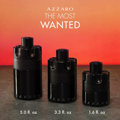 Azzaro The Most Wanted Eau De Parfum black cylindrical bottles in three sizes displayed against a warm orange gradient background