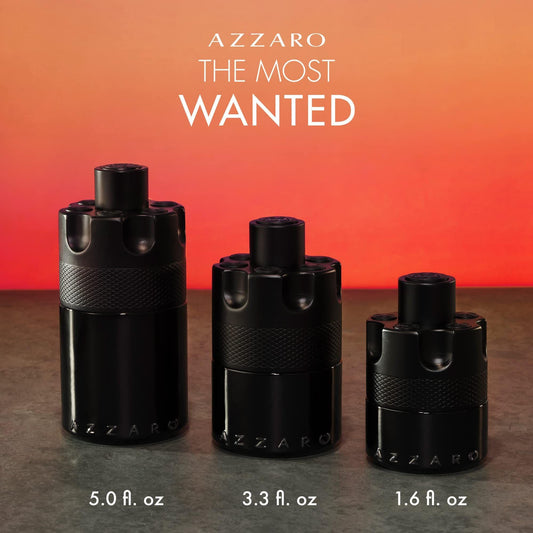Azzaro The Most Wanted Eau De Parfum black cylindrical bottles in three sizes displayed against a warm orange gradient background