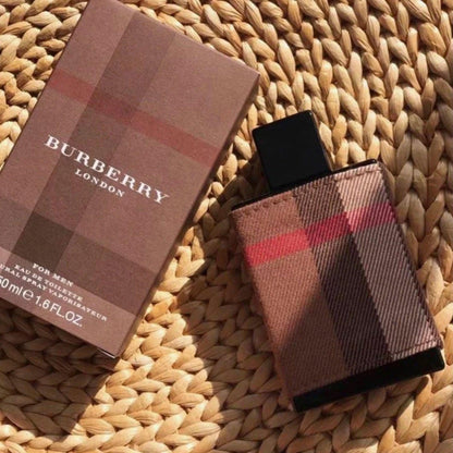 Burberry London for Men Eau De Toilette bottle with signature plaid fabric design and packaging box placed on a woven mat
