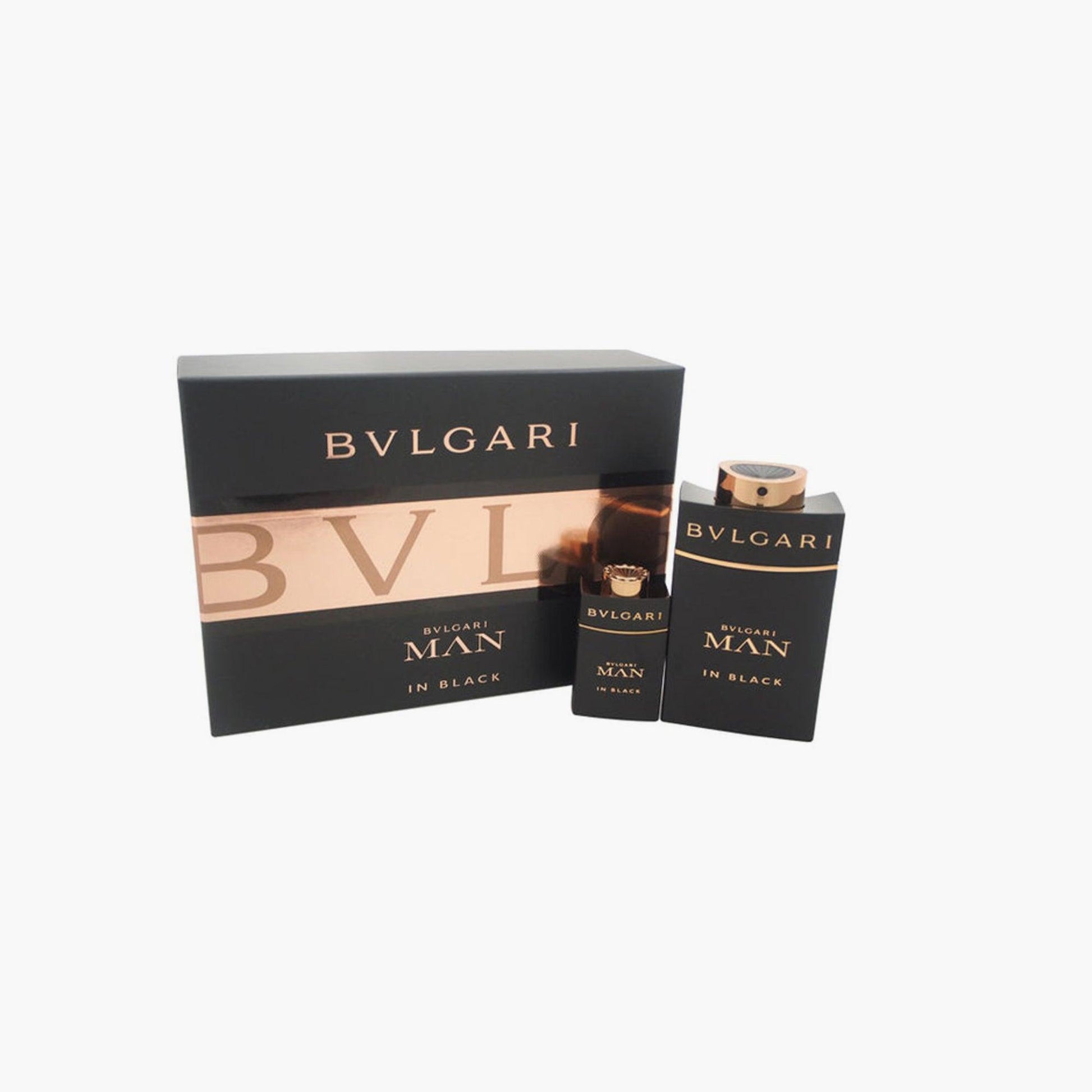 Bvlgari Man In Black gift set featuring two sleek black and gold perfume bottles placed beside a matching black box with copper accents on a white background.