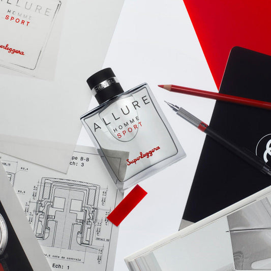 Chanel Allure Homme Sport Superleggera Eau De Toilette bottle placed on white and red designer workspace with sketches, pens, and notebooks