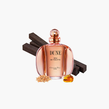 Christian Dior Dune Eau De Toilette perfume bottle in amber tones displayed with wood, grains, and resin accents on a white background