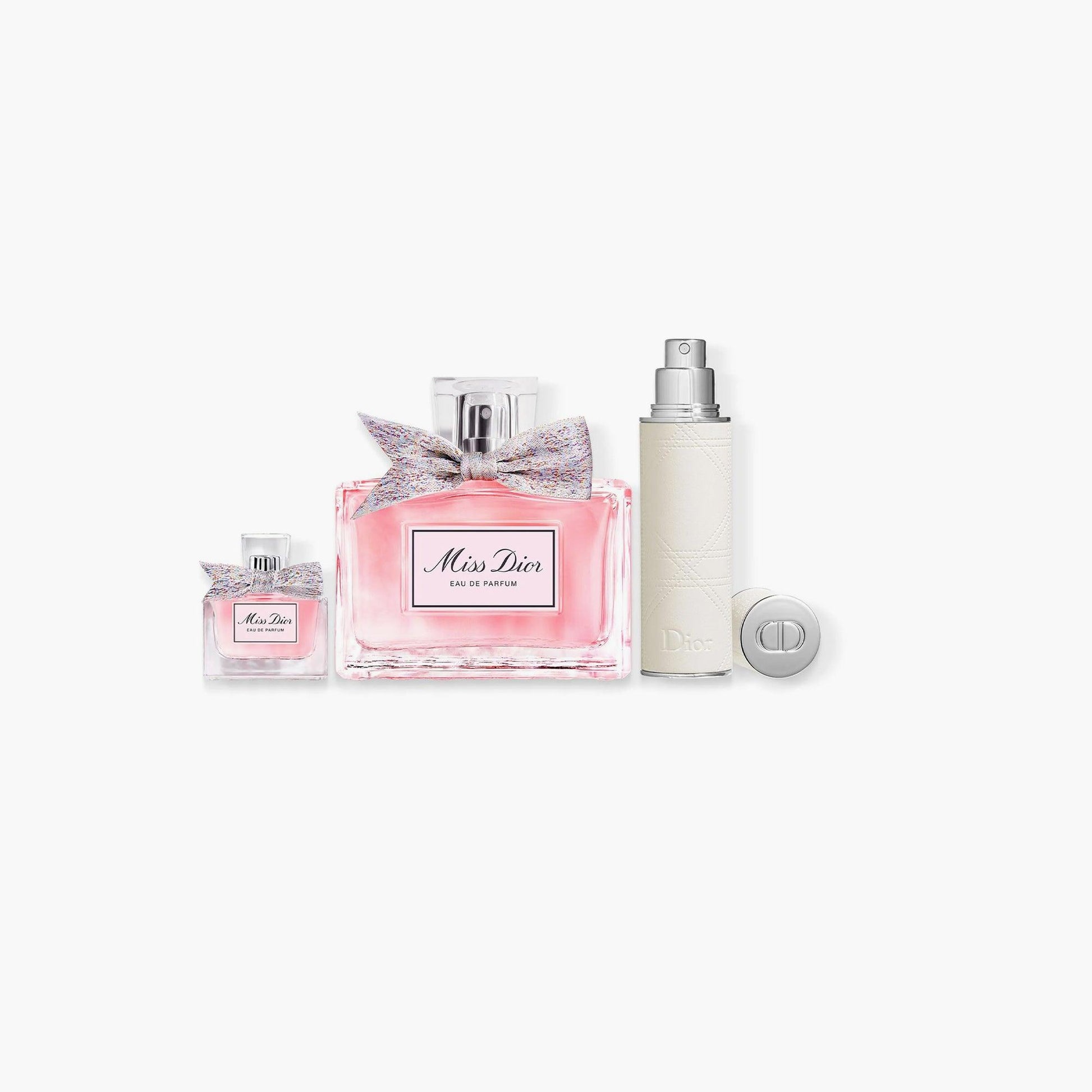 Miss Dior Eau De Parfum gift set with full-size perfume, travel spray, and mini perfume bottle in elegant packaging with colorful bow