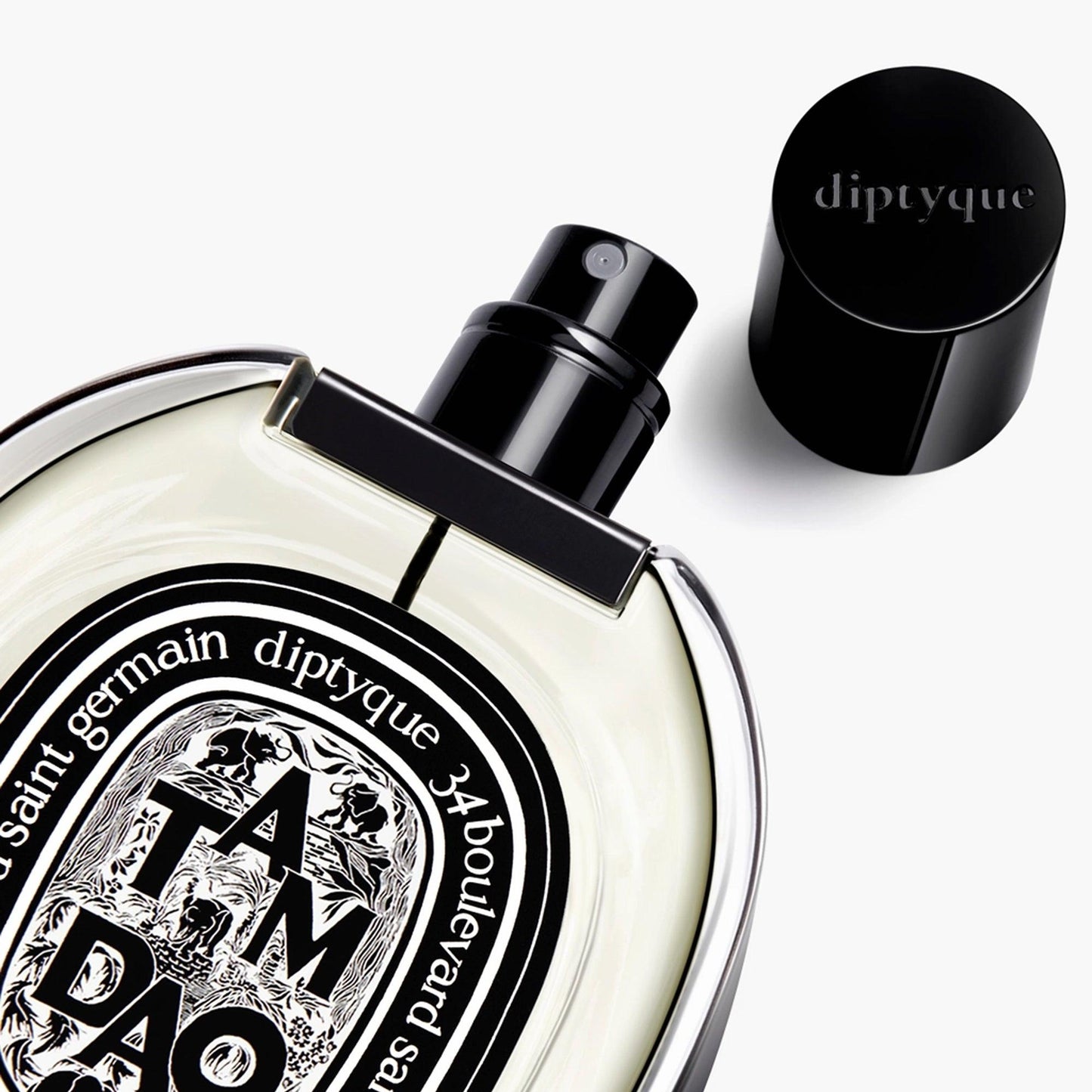 Diptyque Tam Dao perfume bottle with black cap and oval label on white background.