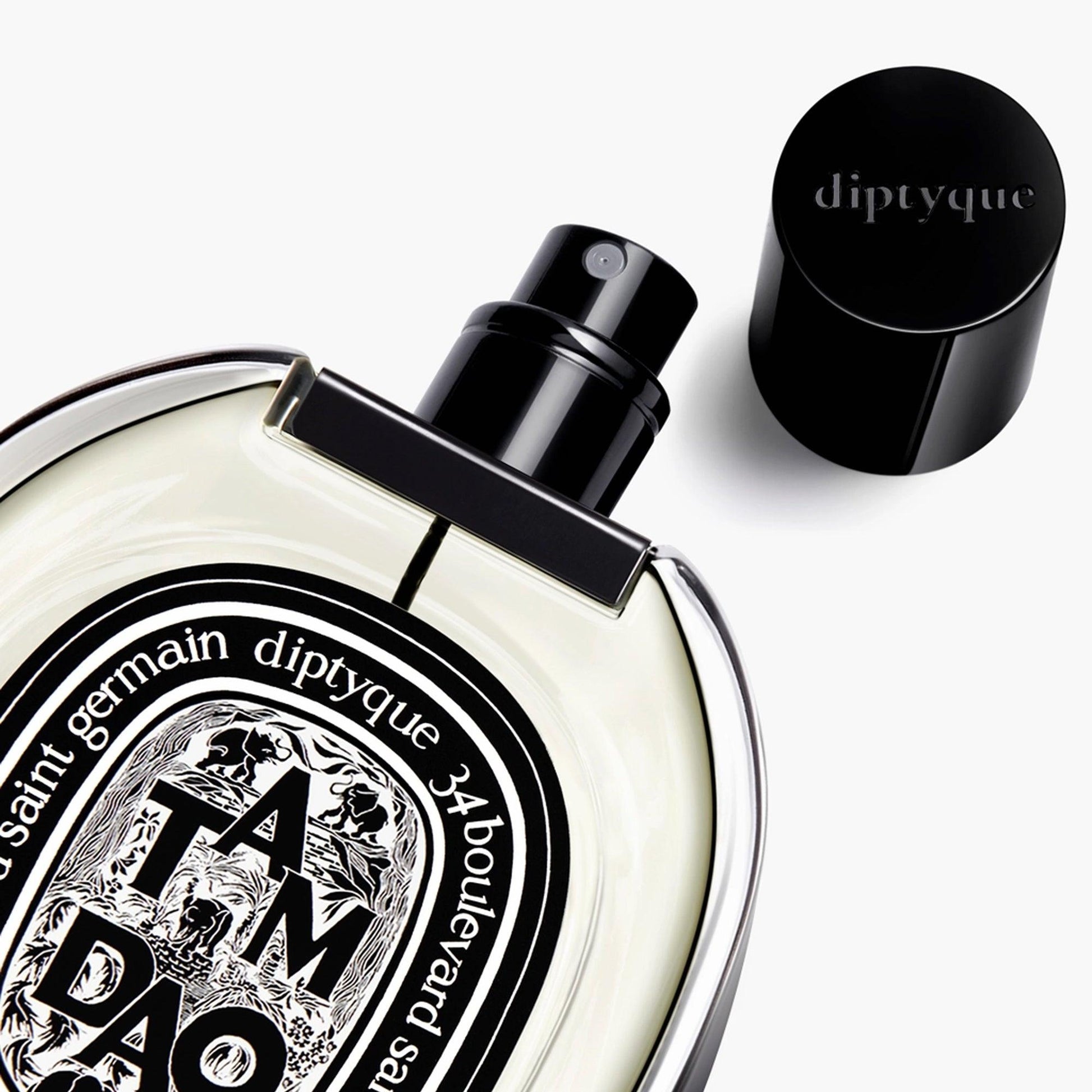 Diptyque Tam Dao perfume bottle with black cap and oval label on white background.