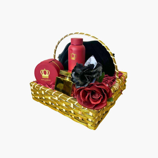 Dolce & Gabbana luxury gift basket with red perfume, lotion, and accessories surrounded by black and red flowers