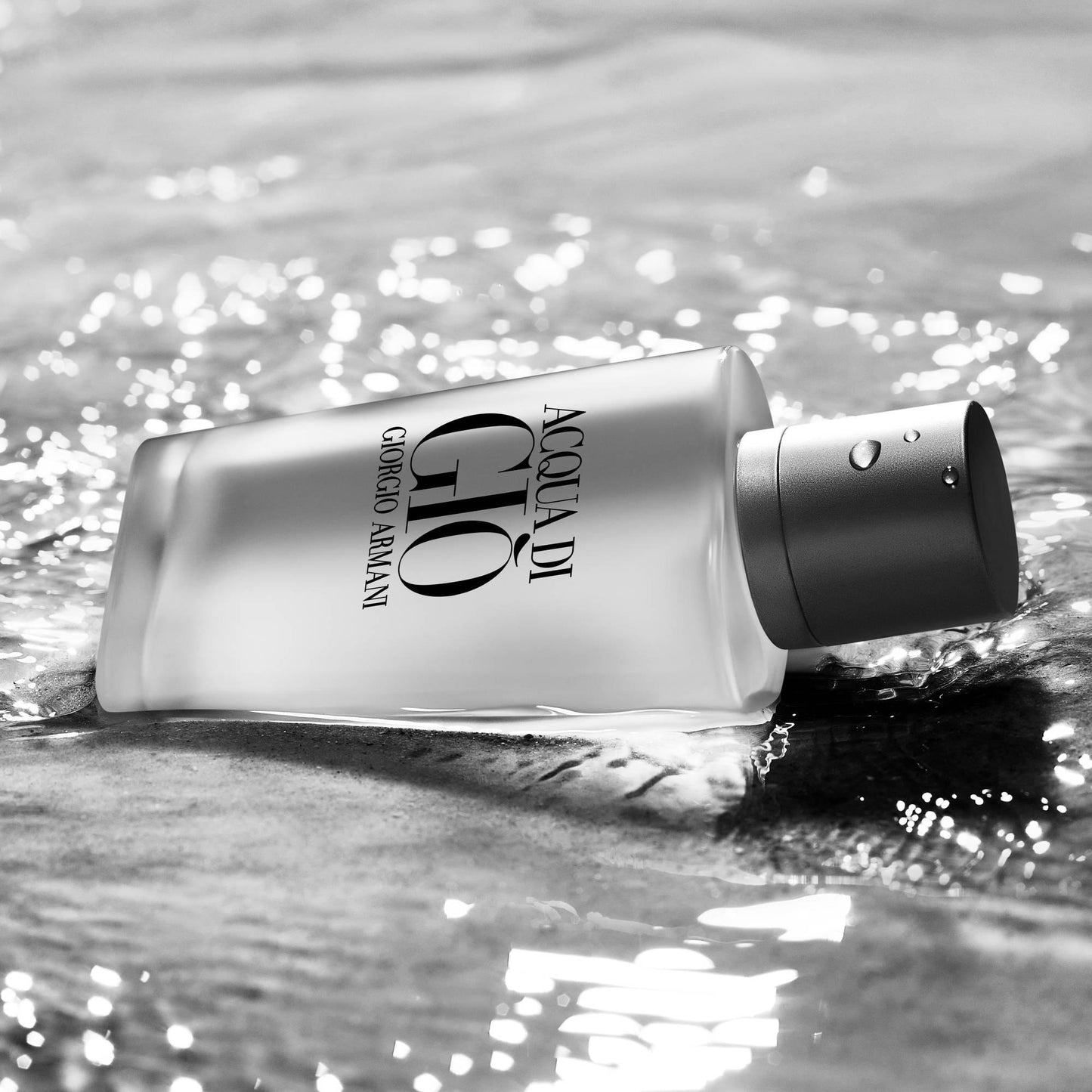 Giorgio Armani Acqua Di Giò Eau De Toilette bottle lying on rippling water with sunlight reflections, showcasing its fresh aquatic essence.