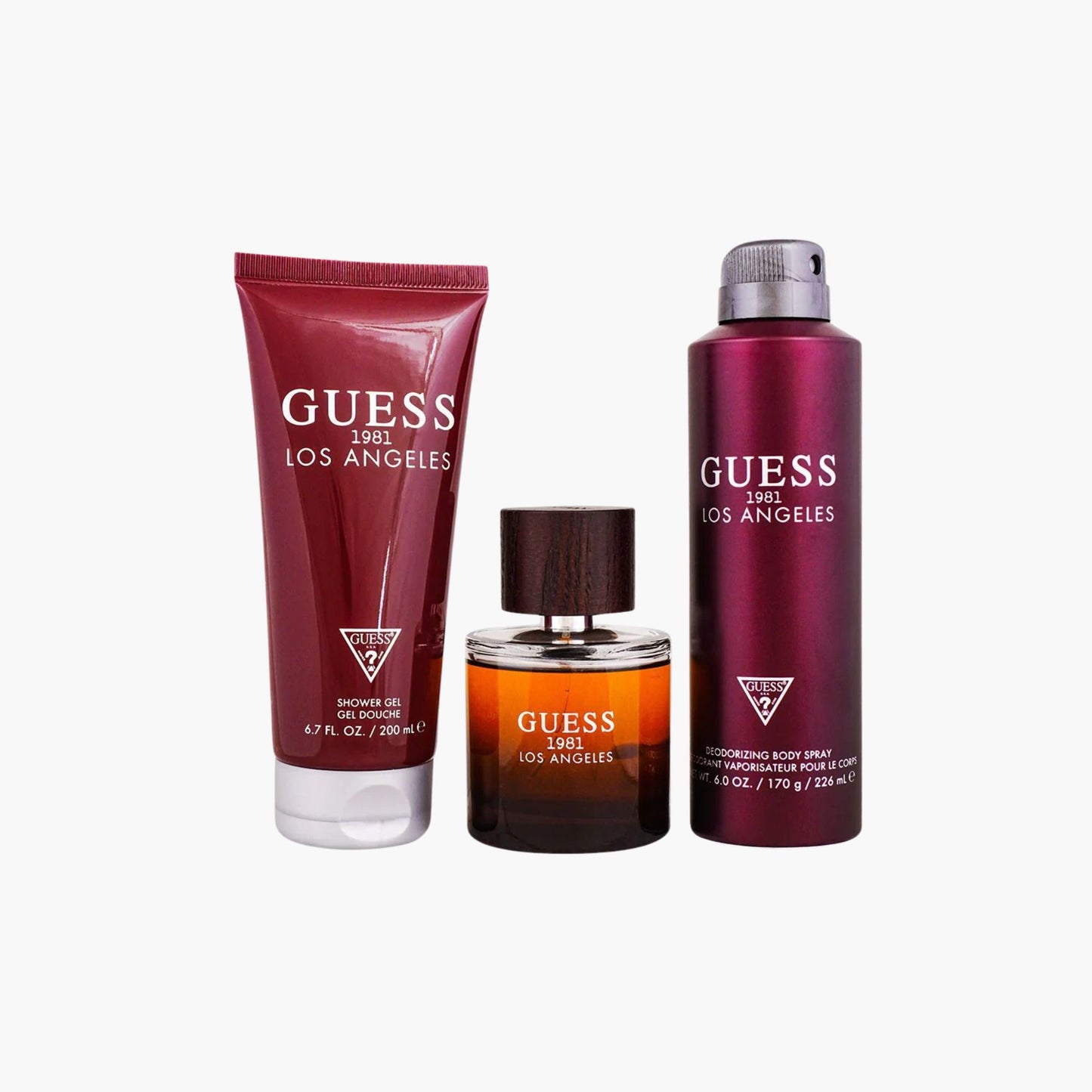 Guess 1981 Los Angeles men's fragrance gift set with a full-size perfume, deodorizing body spray, and shower gel, all featuring deep red packaging.