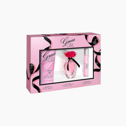 Guess Girl fragrance gift set with pink body lotion, Eau De Toilette bottle with floral cap, and rollerball in a pink striped box packaging