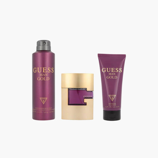Guess Man Gold fragrance gift set featuring a gold and purple bottle of Guess Man Gold Eau de Toilette, a matching deodorizing body spray, and a body lotion, all packaged in a purple and gold box.