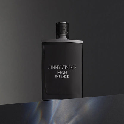 Jimmy Choo Man Intense Eau De Toilette black matte bottle displayed against a dark gradient background, reflecting a bold and masculine design.