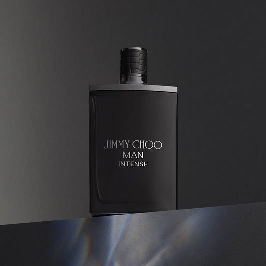 Jimmy Choo Man Intense Eau De Toilette black matte bottle displayed against a dark gradient background, reflecting a bold and masculine design.