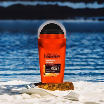 L’Oreal Men Expert Thermic Resist deodorant on sandy beach with blue ocean background