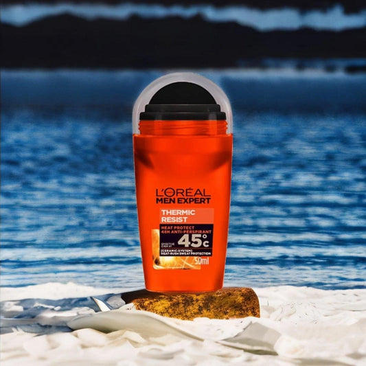 L’Oreal Men Expert Thermic Resist deodorant on sandy beach with blue ocean background